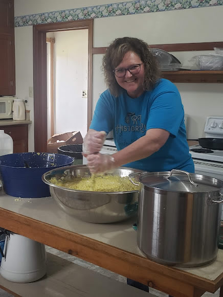 Volunteer making food for a Forever Jen Memorial Fundraiser